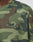 Close-up of a person wearing the LIVE FAST DIE YOUNG Copyright Waffle Longsleeve, an oversized, green and brown camouflage shirt with Ifday embroidered on the chest. Made from 100% Baumwolle for comfort and durability.