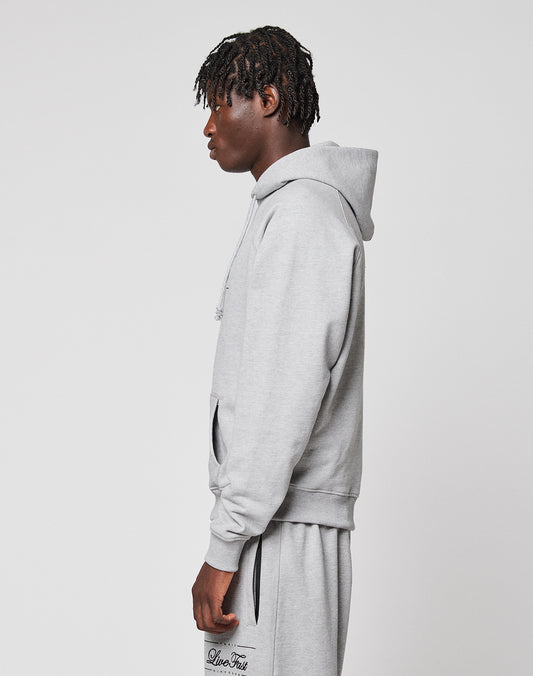 A person with short, textured hair stands sideways in a light gray LIVE FAST DIE YOUNG LFDY Embroidery Hooded and matching sweatpants against a plain white background.
