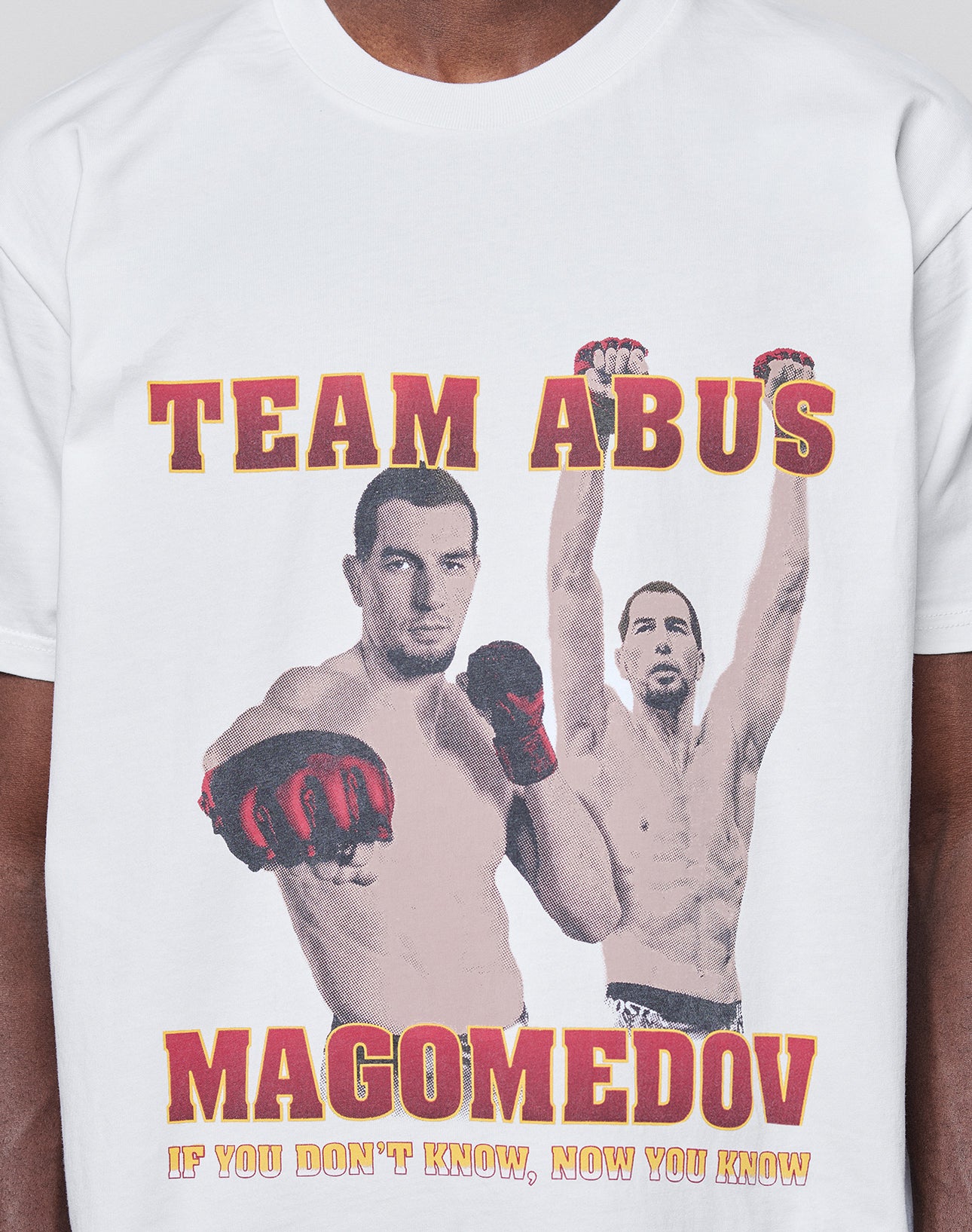 The Abus Magomedov Tee by LIVE FAST DIE YOUNG is a white 100% cotton regular fit T-shirt with front and back prints of a male MMA fighter, bold TEAM ABUS/MAGOMEDOV text, and "IF YOU DONT KNOW, NOW YOU KNOW" in yellow.