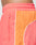 Close-up of a person wearing LIVE FAST DIE YOUNG Beach Shorts in coral pink and orange with zip pockets, a wide elastic waistband, white piping, and a comfortable Regular Fit.