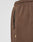 Close-up of LFDY Lightweight Jogger by LIVE FAST DIE YOUNG in brown French Terry, featuring an elastic waistband, black zipper pocket, and small beige tag by the seam. A white underwear waistband is also visible at the top.