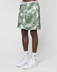 A person wears green and white LFDY Mesh Shorts by LIVE FAST DIE YOUNG (Regular Fit, elastic waistband), white LIVE FAST socks, and white Nike sneakers. Only their legs and lower torso are shown against a plain white background. | model