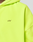 Close-up of the neon yellow LIVE FAST DIE YOUNG Basic Hooded Zip, featuring a small black LFDY™ logo on the chest. The image highlights the hood, partial sleeve, and signature branding on this oversized fit.