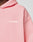 Close-up of a person wearing the LIVE FAST DIE YOUNG Basic 360 Hooded in light pink, featuring white LiveFast text on the left chest, topstitching details, and an oversize fit. Set against a plain, neutral background.