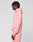 A person with short, twisted hair stands sideways, wearing a pink LIVE FAST DIE YOUNG Basic 360 Hooded sweatshirt and matching sweatpants with topstitching, against a plain light gray background.