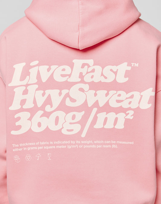 Someone wearing the LIVE FAST DIE YOUNG Basic 360 Hooded in pink—a bold white back print and oversize fit, crafted with heavy 360g/m² fabric (thickness measured by grams per square meter), plus detailed topstitching.