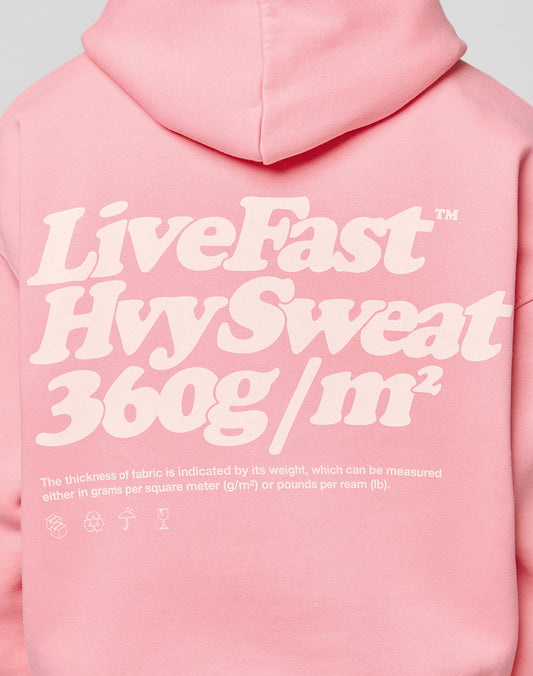 An oversize pink Basic 360 Hooded by LIVE FAST DIE YOUNG with bold white text on the back. Features 360g/m² fabric, smaller explanatory text, and quality topstitching for extra durability.