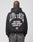 A person faces away from the camera wearing a black, oversized LIVE FAST DIE YOUNG Live Fast Lenox Hooded Zip, made of Baumwolle, with bold front and back prints including JIM JONES LENOX AVENUE HARLEM, NY and a small American flag on the back.