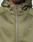 Close-up of a person wearing the LIVE FAST DIE YOUNG LFDY Scuba Hooded Zip in olive green. The regular fit hoodie has a drawstring hood and white LFDY™ print on the left chest, with only the lower face visible.