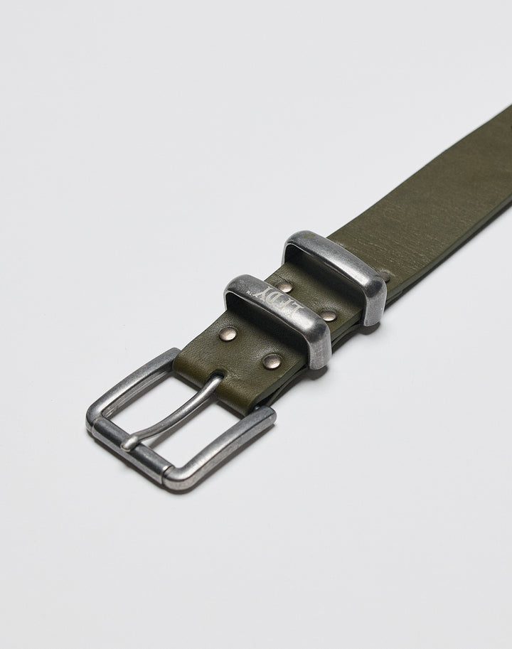 A close-up of the LFDY Signature Belt by LIVE FAST DIE YOUNG, featuring green leather, a silver metal buckle, two metal loops, and decorative studs, displayed on a plain white background.