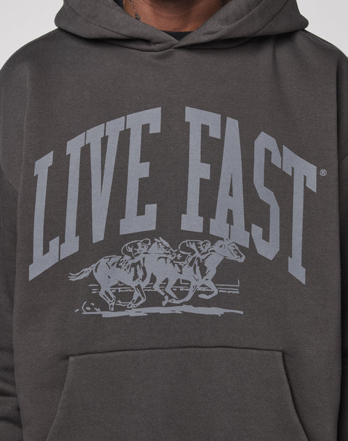 The Live Fast Stallion Hooded by LIVE FAST DIE YOUNG is an oversized charcoal hoodie featuring bold LIVE FAST text above two jockeys on racing horses, crafted from soft Baumwolle cotton.