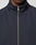 A close-up shows a person wearing the LFDY Striped Track Jacket by LIVE FAST DIE YOUNG, featuring a dark navy color, high collar, raglan sleeves, and a centered silver zipper. Only the lower half of the face and upper chest are visible.