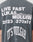 Back of gray It’s Vulgar Tee by LIVE FAST DIE YOUNG features bold white prints: LIVE FAST LUKAS MULLER 2023 370x51 ITS VULGAR. MULLER is in layered, offset letters. Oversize fit, made from 100% Baumwolle.