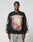 A man wears the LFDY Angel Sweater by LIVE FAST DIE YOUNG—an oversized black Baumwolle sweatshirt with LIVE FAST text above a vibrant graphic and bold OR DIE BY IT text on the sleeves, standing against a plain light background.