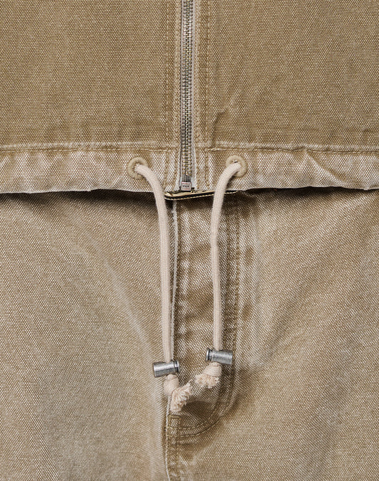 Close-up of the Faded Workwear Jacket by LIVE FAST DIE YOUNG—tan, oversize fit with a metal zipper, kangaroo pocket, metal-tip drawstring, and textured fabric.