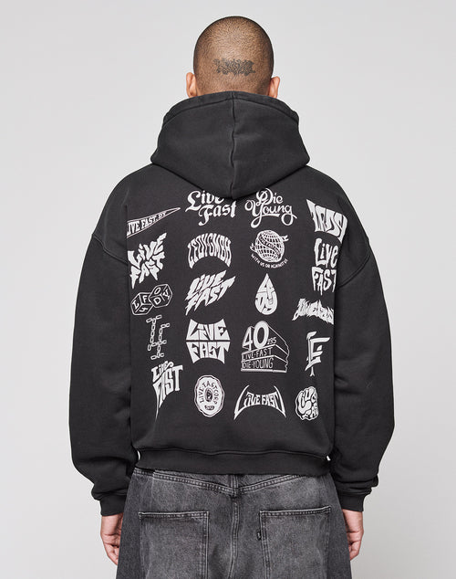A person faces away from the camera in a black LIVE FAST DIE YOUNG LFDY Logo Hooded Zip, an oversized Baumwolle hoodie with multilogo white graphics and “Live Fast” and “Die Young” phrases on the back, set against a plain gray background.