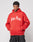 A person models the LIVE FAST DIE YOUNG Live Fast Fractured Hooded, an oversize bright red hoodie with a doppellagige Kapuze and bold white “Live Fast” print, against a plain light gray background.