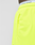 Close-up of a person wearing LFDY Guaranteed Mesh Shorts by LIVE FAST DIE YOUNG in neon yellow. These wide fit polyester shorts feature a zippered side pocket and an elastic waistband. Branded LIVE FAST underwear is visible; the background is plain and light.