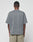 A person faces away from the camera, wearing a loose Basic +49 Chest Tee by LIVE FAST DIE YOUNG in faded gray and light beige mesh oversize shorts, set against a plain white background.