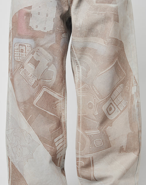 Close-up of the LFDY Stolen Phones Denim by LIVE FAST DIE YOUNG, crafted from 100% Baumwolle and featuring an all-over print of vintage electronic devices in muted brown and white tones.