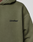 Close-up of the Basic 360 Hooded by LIVE FAST DIE YOUNG in olive green, featuring soft fabric, subtle topstitching, and black LiveFast™ text on the chest. The hood is partially visible at the upper left.