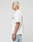 A person with short bleached blond hair stands in profile, wearing the LIVE FAST DIE YOUNG LFDY Boxy Jersey and light blue distressed jeans against a plain light background.