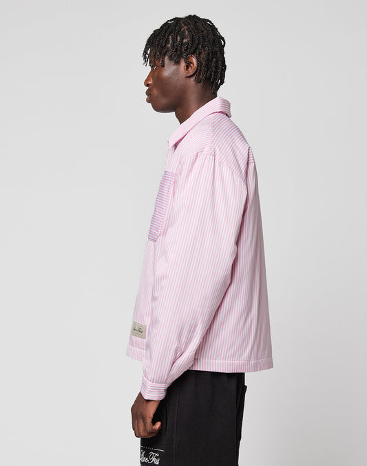 A person with short, textured hair stands in profile against a light gray background, wearing the LFDY Striped Padded Shirt by LIVE FAST DIE YOUNG and black shorts.