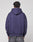 Someone is seen from behind, wearing the LIVE FAST DIE YOUNG Live Fast Stallion Hooded in purple (Oversize Fit) and faded gray jeans, set against a plain light gray background.