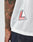 A tattooed arm is shown beside the hem of a white LFDY Mesh Jersey by LIVE FAST DIE YOUNG, featuring a red and white L LIVE FAST patch. The person also wears dark blue jeans.