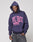 A person in the LIVE FAST DIE YOUNG Live Fast Stallion Hooded, an oversize dark purple hoodie aus Baumwolle with bold pink LIVE FAST frontprint above racing horses, pairs it with dark gray jeans against a plain light background.