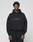 A person wearing the LIVE FAST DIE YOUNG Basic Livefast Hooded in black, featuring a bold "LiveFast" front print and an oversize fit, pairs it with black pants against a plain light gray background.