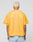 A person with short, bleached blonde hair is seen from behind wearing the LIVE FAST DIE YOUNG LFDY Boxy Jersey in yellow mesh and light blue jeans, set against a plain gray background.