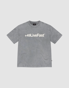 The Basic +49 Tee by LIVE FAST DIE YOUNG is a grey oversized short-sleeve t-shirt featuring a bold white +49LiveFast™ front print, made from 100% cotton and shown on a plain light background. | plain