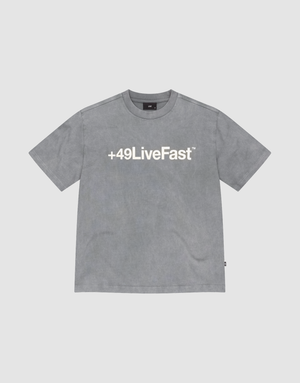 The Basic +49 Tee by LIVE FAST DIE YOUNG is a grey oversized short-sleeve t-shirt featuring a bold white +49LiveFast™ front print, made from 100% cotton and shown on a plain light background. | plain