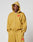 A person wears the LIVE FAST DIE YOUNG Live Fast Sweatsuit Jacket—an oversize fit mustard yellow zip-up hoodie with hood up, bold red front graphic, and LIVE FAST text—paired with matching sweatpants. Plain white background.