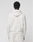 A person stands with their back to the camera, dressed in the LFDY Heavyweight Lounge Zip Hooded by LIVE FAST DIE YOUNG and matching sweatpants, both off-white and made from 100% Baumwolle, against a plain light background.