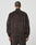 Someone with short hair is seen from behind, wearing the LIVE FAST DIE YOUNG LFDY Velour Jacket in an oversized dark brown fit with a chevron seam on the back, stand-up collar, and elasticated cuffs and waistband.