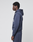 A person stands in profile against a plain light background, wearing the LIVE FAST DIE YOUNG LFDY Heavyweight Lounge Hooded in dark blue and matching sweatpants, both 100% Baumwolle and Regular Fit, with hands by their sides.