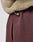 Close-up of a person wearing the LIVE FAST DIE YOUNG LFDY Teddy Jacket in an oversized tan fit, paired with maroon sweatpants featuring an elastic drawstring and visible side pocket. The fabric textures are clearly shown.