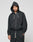A person in a black LIVE FAST DIE YOUNG LFDY Lightweight Hooded Zip with the hood up and matching black sweatpants stands against a light gray background, looking directly at the camera with a neutral expression.