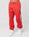 A person wears the LIVE FAST DIE YOUNG LFDY Haters Jogger—wide fit red sweatpants with white graphic text on one leg, an elastic waistband and cuffs—paired with white sneakers, against a plain light background. Made from a cotton polyester mix.