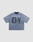 The LIVE FAST DIE YOUNG Faded Waffle Jersey is a loose, oversized, short-sleeve blue-gray t-shirt made from 100% Baumwolle, featuring large dark DY letters in a faded print on the front, laid flat on a light gray background.