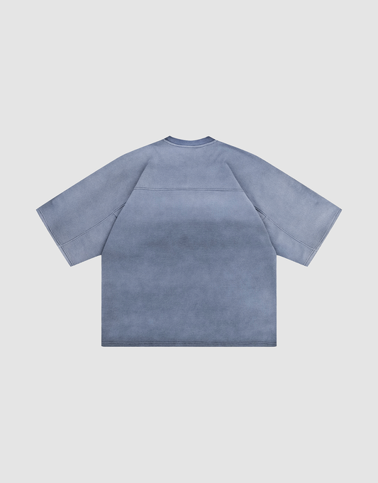 The LIVE FAST DIE YOUNG Faded Waffle Jersey is a loose, short-sleeved blue-gray Oversize Fit T-shirt with a washed gradient effect, made from 100% Baumwolle. Shown from the back, laid flat on a white background.