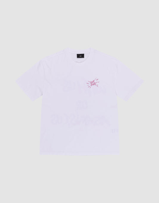 The LFDY Against Us Tee by LIVE FAST DIE YOUNG is a plain white, 100% Baumwolle short-sleeve shirt with a small pink front print and text on the left chest, shown laid flat on a light grey background.