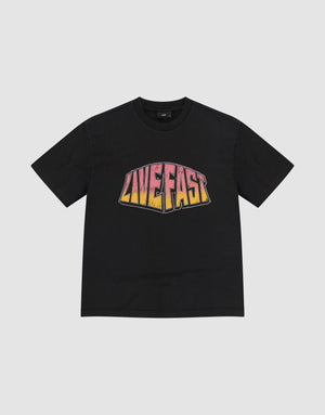 The LFDY Emblem Tee by LIVE FAST DIE YOUNG is a black oversize t-shirt with "LIVE FAST" in bold pink, orange, and yellow gradient print on the chest. Made from 100% Baumwolle and shown flat on a plain light gray background. | plain