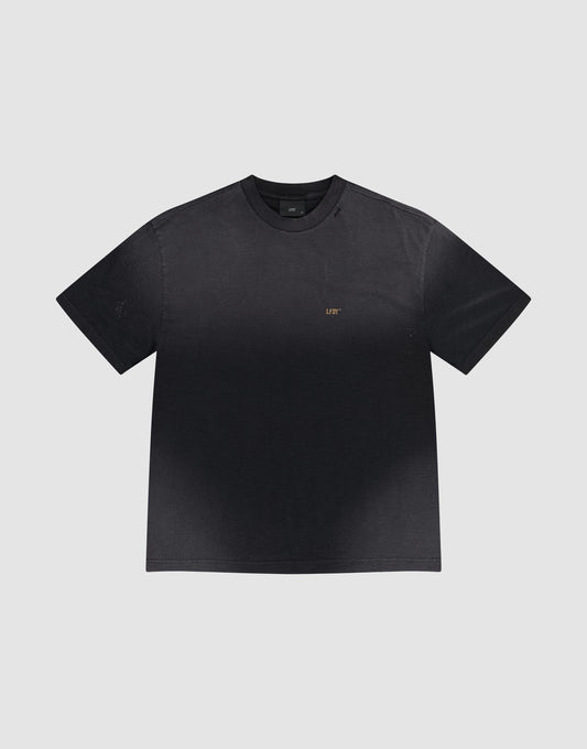 The LFDY Hinterhof Tee by LIVE FAST DIE YOUNG is a black cotton-slub short-sleeve t-shirt featuring a subtle gradient and small gold "LIFT" lettering on the left chest, shown against a plain light gray background.