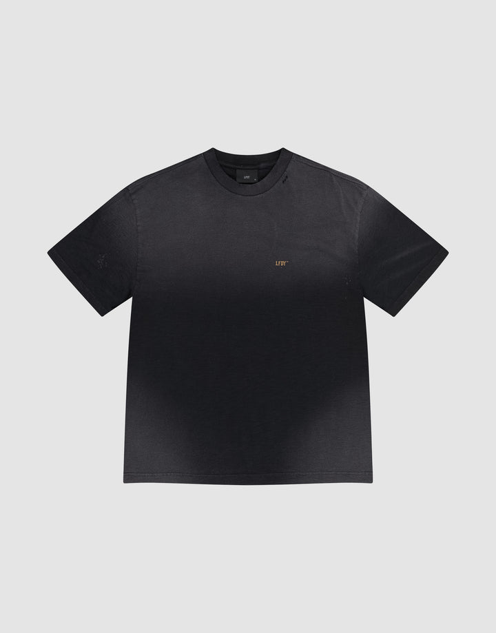 The LFDY Hinterhof Tee by LIVE FAST DIE YOUNG is a black cotton-slub short-sleeve t-shirt featuring a subtle gradient and small gold "LIFT" lettering on the left chest, shown against a plain light gray background.
