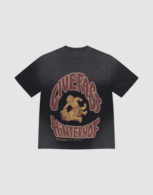 The LFDY Hinterhof Tee by LIVE FAST DIE YOUNG is an oversized black tee with a stylized horse rider graphic and bold “GIVEFAST HINTERHOF” text, crafted from soft cotton-slub and finished with a unique vintage wash. | plain