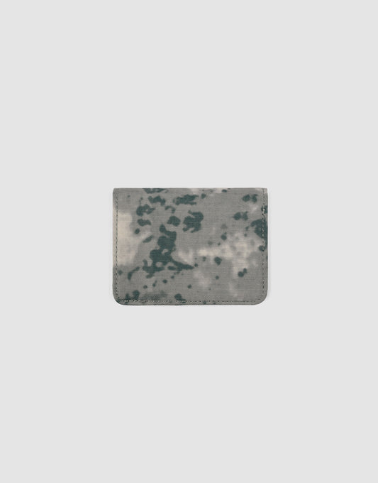 The LFDY Cardholder by LIVE FAST DIE YOUNG is a compact, rectangular women’s wallet with a gray and dark green abstract camo pattern and practical card slots, displayed on a plain light gray background.