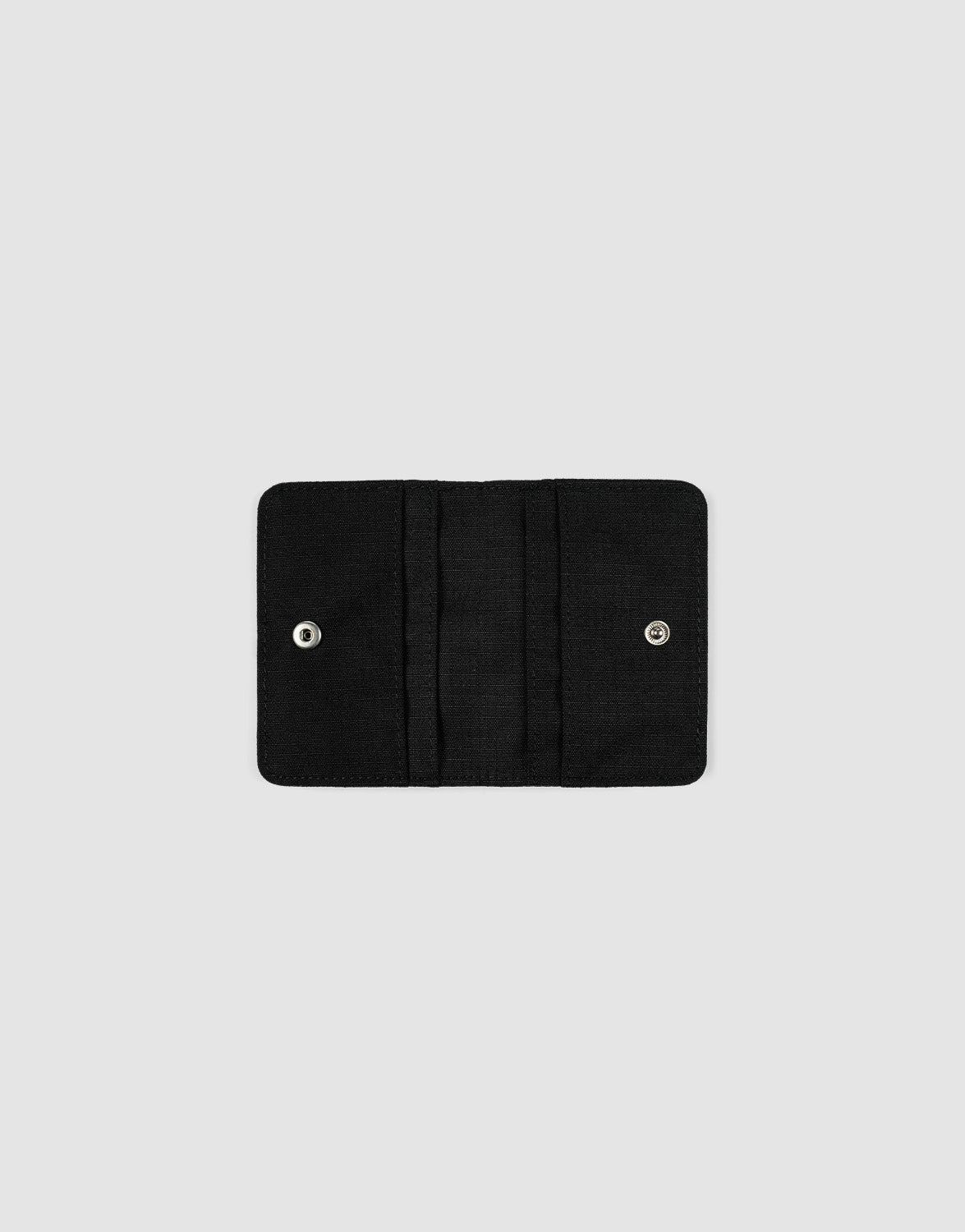 The LFDY Cardholder by LIVE FAST DIE YOUNG is a black fabric wallet, open and empty against a plain light gray background. It features a Druckknopf-Verschluss and multiple Kartenfächer inside.